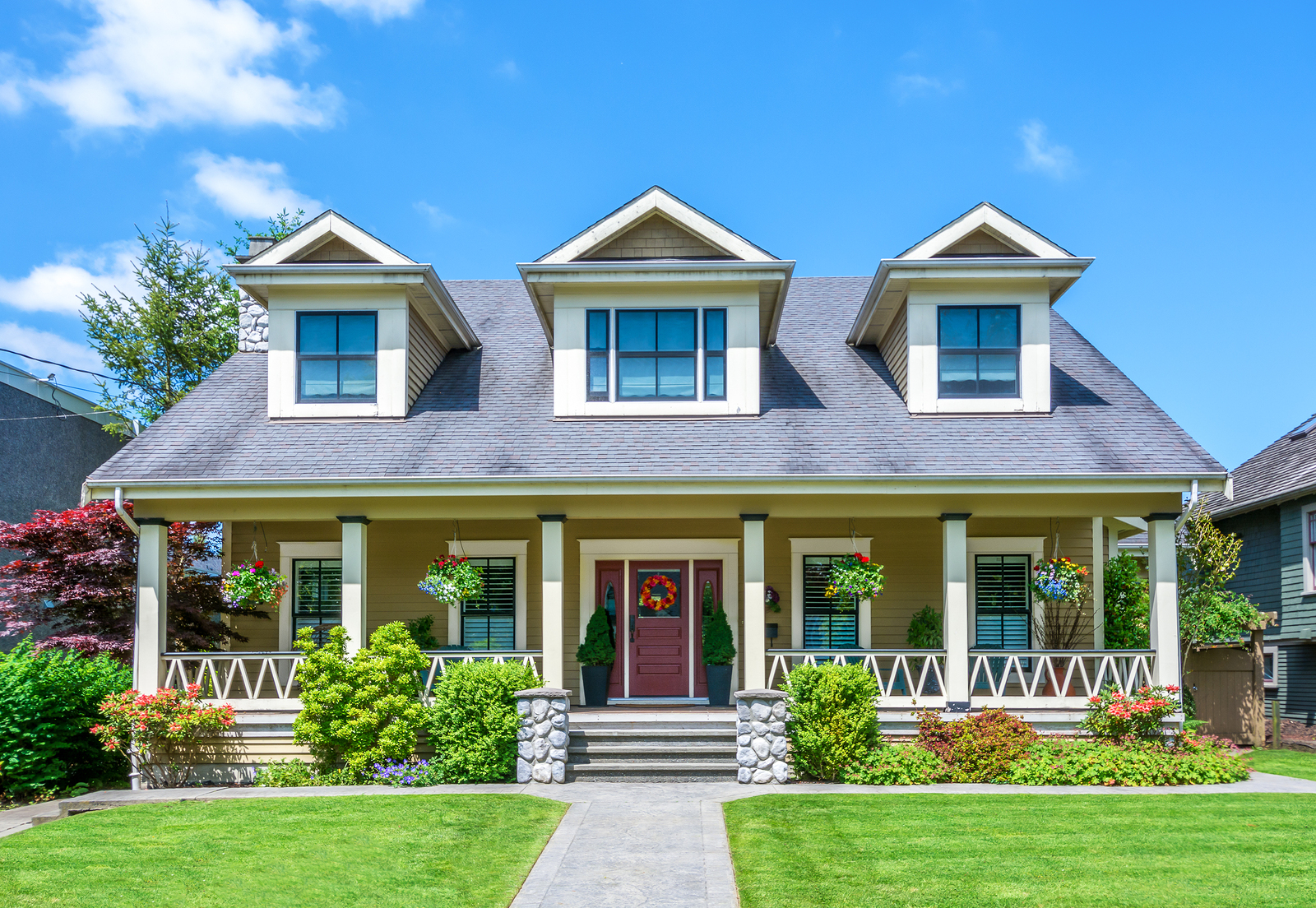 Luxury house with beautiful landscaping on a sunny day. Home exterior.